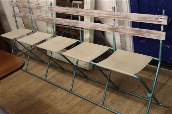 A set of French folding canvas circus seats L.230cm